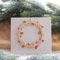 Suspension – Couronne de houx rouge – Räder
